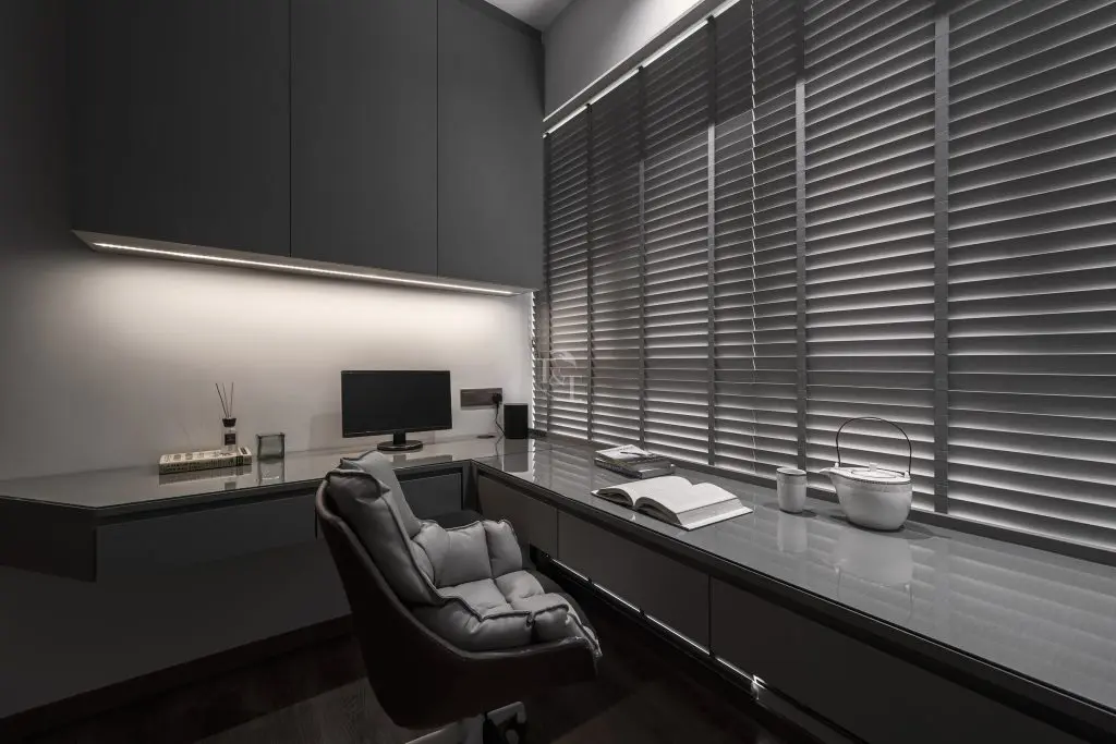 Contemporary home office with built-in desk and window blinds
