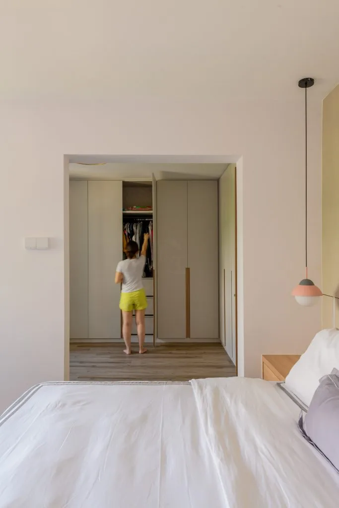 Bedroom with walk-in wardrobe and modern storage design