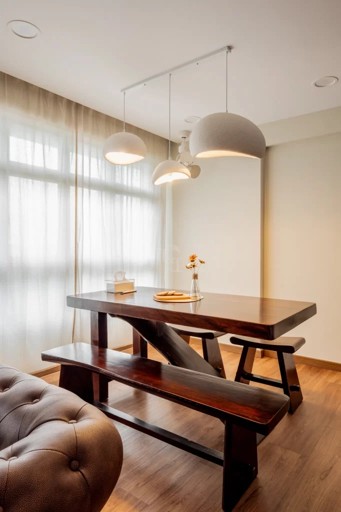Minimalist dining area with wooden table and pendant lights